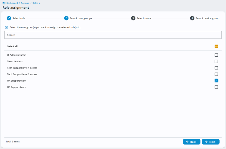 Role assignment screen in 247connect showing step 2, Select user groups. A list of six groups is displayed with checkboxes, including IT Administrators, Team Leaders, Tech Support levels 1 and 2, and UK/US Support teams. The UK Support team group is selected. Navigation buttons for Back and Next appear at the bottom.